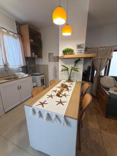 a kitchen with a table with starfish on it at Apê Charm Jeri in Jericoacoara