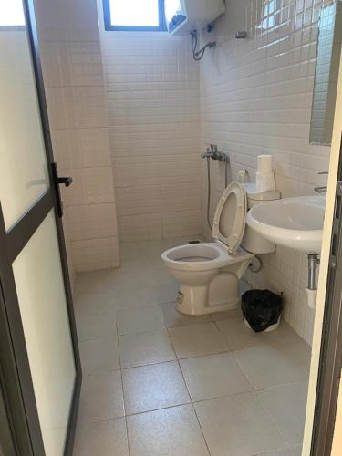 a bathroom with a toilet and a sink at Ngan Nga in Bắc Hà