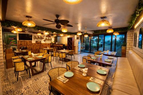 a restaurant with tables and chairs in a room at Amega Hotel in Tagaytay