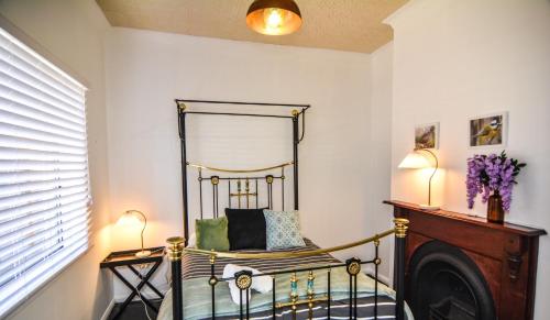 a room with a chair and a mirror at Comfortable Victorian Terrace close to shops in Lithgow