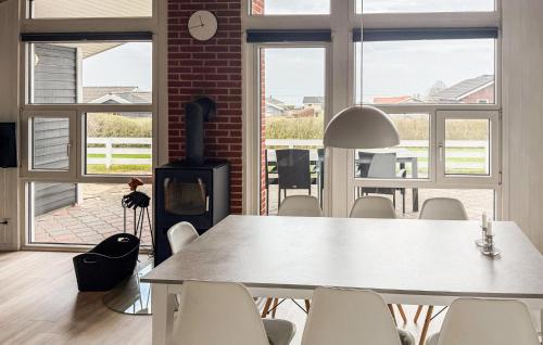a room with a table and chairs and a fireplace at Holiday Home Bygmarken Sjølund Xii in Sjølund