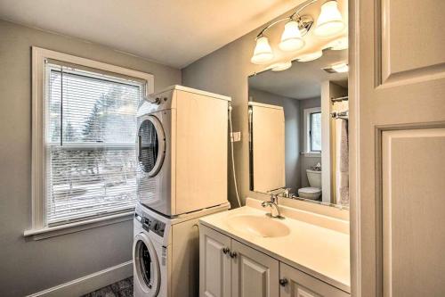 a bathroom with a washer and dryer next to a sink at Relaxing Getaway Near Everything in Kennebunk