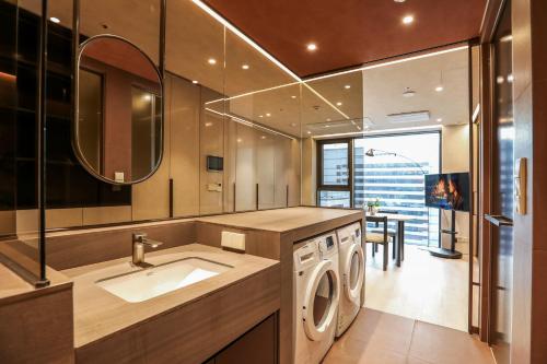a bathroom with a washing machine and a sink at ASTY Cabin Seoul Serviced Residence in Seoul