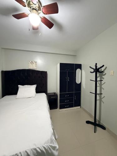 a bedroom with a bed and a ceiling fan at Estancia La Luna in Huarmey