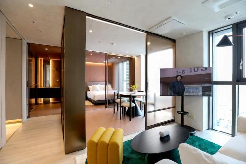 a living room with a room with a bed and a table at ASTY Cabin Seoul Serviced Residence in Seoul