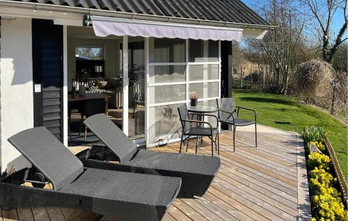 a deck with chairs and a table on a house at 3 Bedroom Cozy Home In Haderslev in Haderslev