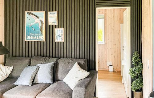 a living room with a gray couch in a room at Stunning Home In Farsø With Sauna in Farsø