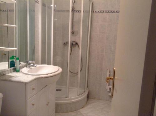 a bathroom with a shower and a sink at Residence les Goelands in Ouistreham
