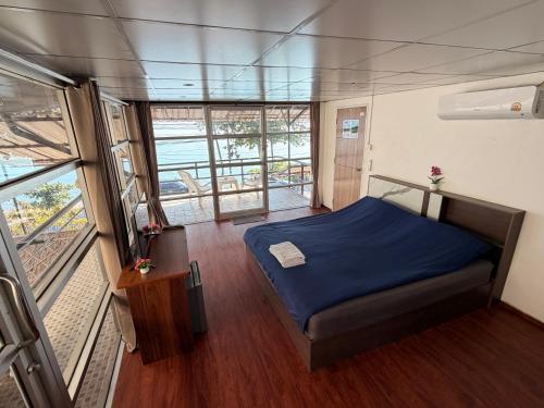 a bedroom with a blue bed in a room at Moonlight Samui hotel and bar in Koh Samui