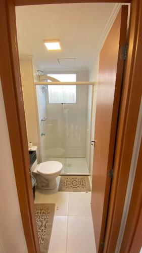 a bathroom with a white toilet and a shower at Comfortable, well-located, renovated apartment in São Leopoldo