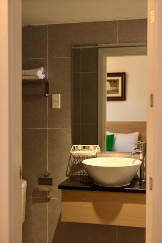 a bathroom with a bowl sink on a counter at The Charm Boutique Hotel Hue in Hue