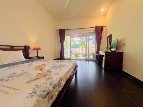 a bedroom with a bed with towels on it at Terrace Resort in Phú Quốc