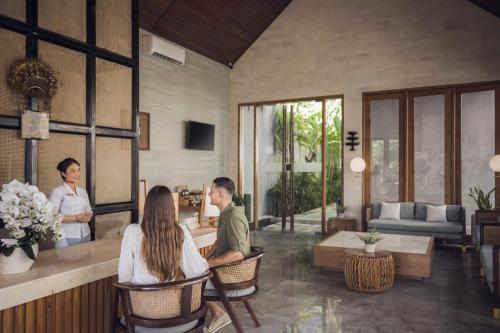 a group of people sitting in a living room at Astera Villa Seminyak by Ini Vie Hospitality in Seminyak