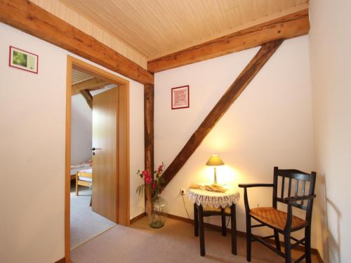 a room with a table and a chair and a hallway at Reihenhäuser in Strackholt in Strackholt