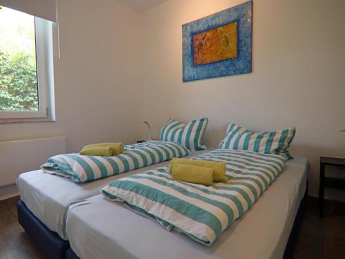 two beds with pillows on them in a room at Doppelhaushälfte Seestern, Lohmen in Lohmen