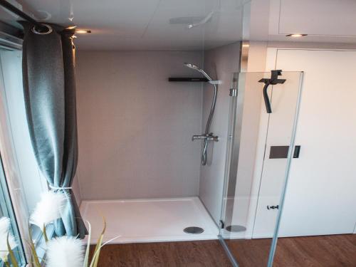 a shower with a glass door in a bathroom at behagliches Floating Home in Berlin in Berlin