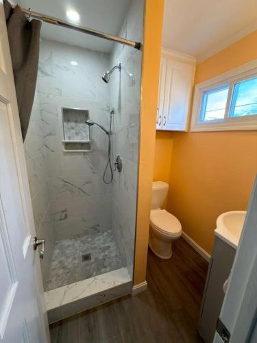 a bathroom with a shower and a toilet at Oceanview Loft York in York