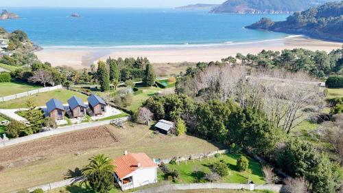 an aerial view of a house and the beach at The Cliffs - Casa Alecrin in O Vicedo