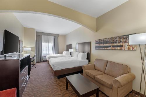 a hotel room with a bed and a couch at Best Western Plus Capital Inn in Jefferson City