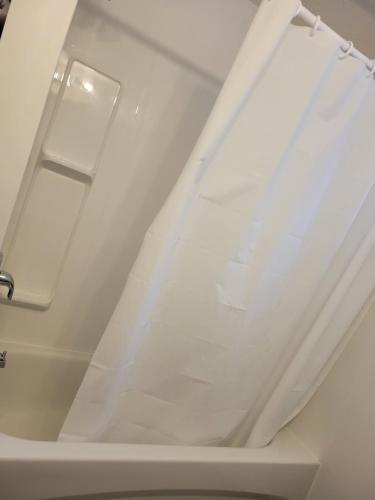 a white ceiling with a window in a bathroom at Executive Cozy 2bedroom Basement Suite in Brandon