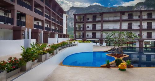 a hotel with a swimming pool in the middle of a courtyard at The Lai Thai Luxury Condominiums in Ao Nang Beach