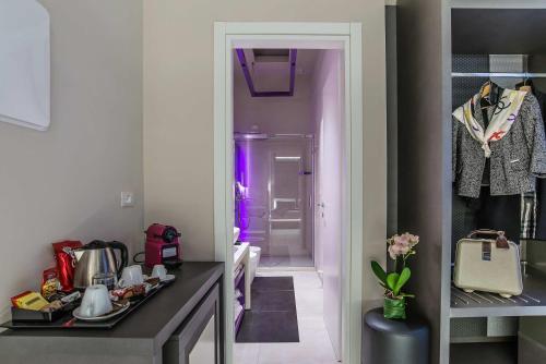 a room with a walk in closet with purple lighting at Via Veneto Prestige Rooms in Rome