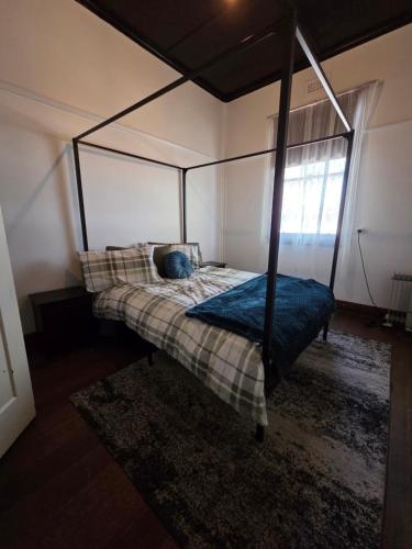 a bedroom with a canopy bed in a room at The Caramut Hotel in Caramut