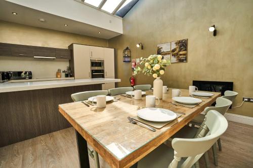 a dining room with a large wooden table and chairs at 1 The Kings within the City Walls in York