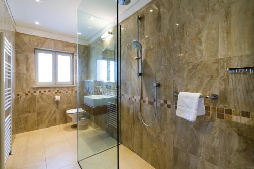 a bathroom with a glass shower and a sink at 5 bedroom Villa Rio with large private pool and hot tub, Aphrodite Hills Resort in Kouklia