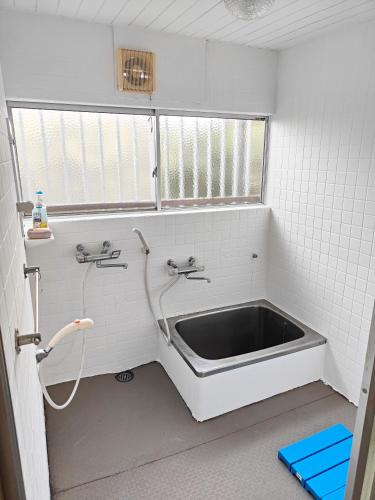 a bathroom with a sink and a window at 海っぺり宮崎 in Miyazaki