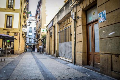 an empty street in a city with buildings at Beach Break Guesthouse in Donostia-San Sebastián