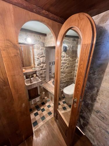 a bathroom with a toilet and a sink at La Torre della Bella Ragazza in Suvereto