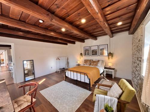 a bedroom with a bed and a living room at Dandelion Vintage in Nemesgulács