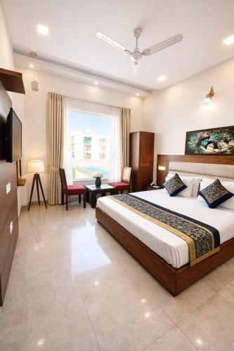 a hotel room with a large bed and a desk at The WoodLuck Zirakpur Chandigarh - Sidham Group of Hotels in Chandīgarh