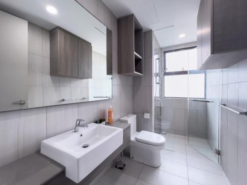 a white bathroom with a sink and a toilet at Luxury Condo Datum Jelatek Near KLCC,free Parking in Kampong Datok Keramat
