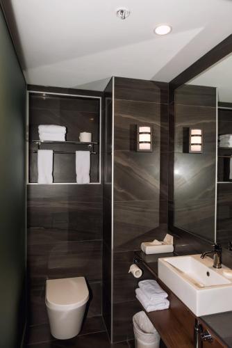 a bathroom with a toilet and a sink at Waipuna Hotel & Conference Centre in Auckland