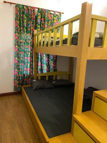 a bedroom with a bunk bed and a curtain at Nhà Bên Suối Retreat in Làng Tè