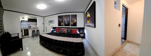 a bedroom with a black bed in a room at Book & Sleep Cancun in Cancún