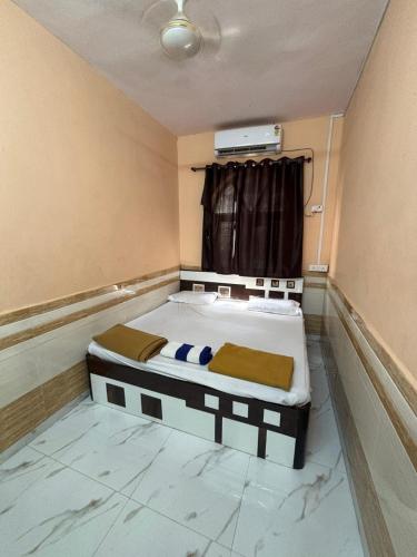 a room with two beds and a window at YR'S Nature Farmhouse in Badlapur