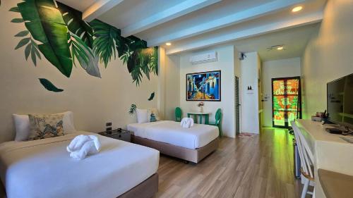 a hotel room with two beds and a sink at พัทลุงเมริเดียนโฮเทล in Phatthalung