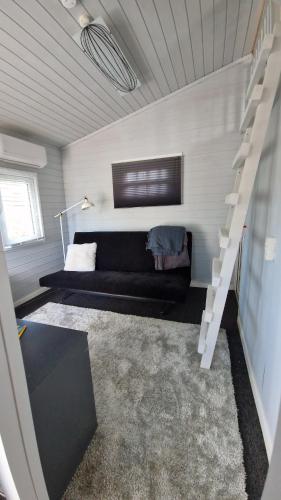 a living room with a couch and a staircase at Nalle's in Stavtrup
