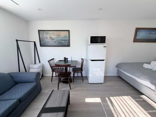 a living room with a couch and a table at Claremont Comfort Cottage in Claremont