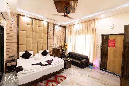 a bedroom with a bed and a couch at Rath Inns Beach Resort Mandarmani in Mandarmoni