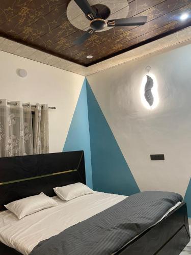 a bedroom with a ceiling fan and a bed at Yovibe Stays, Dorms & Rooms, Assi Ghat, Varanasi in Varanasi