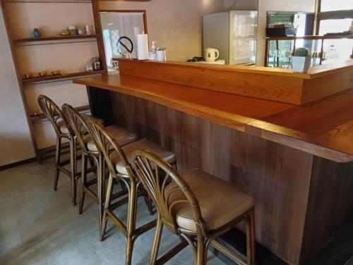 a row of chairs at a bar in a restaurant at HOTEL Saboten Apartment in Miyoshi