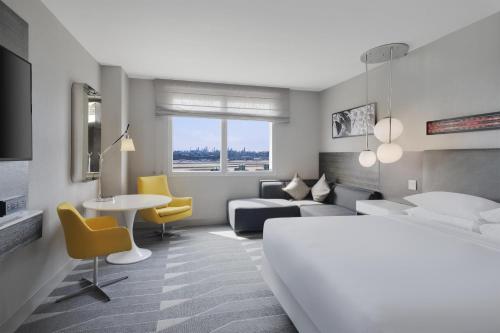 a hotel room with a bed and a table and chairs at Hyatt Regency Los Angeles International Airport in Los Angeles