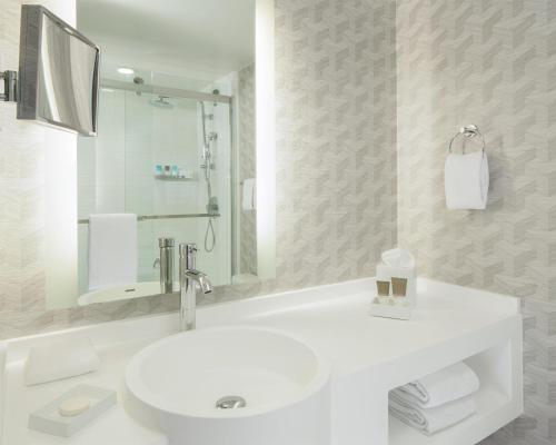 a white bathroom with a sink and a mirror at Hyatt Regency Los Angeles International Airport in Los Angeles