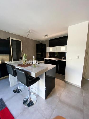 a kitchen with a large white island with black cabinets at Villa Martina in Novigrad Istria