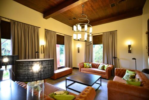 a living room with couches and a table at Hotel Guaminí Misión in Puerto Iguazú