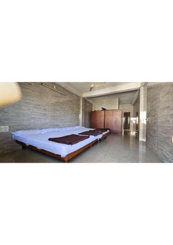 a large room with a large bed in it at Netrani Residency in Māvalli
